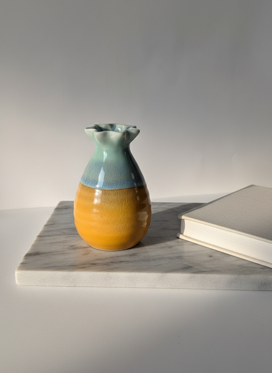 Two-Tone Orange Glazed Mini Ceramic Vase on White with Marble and Book